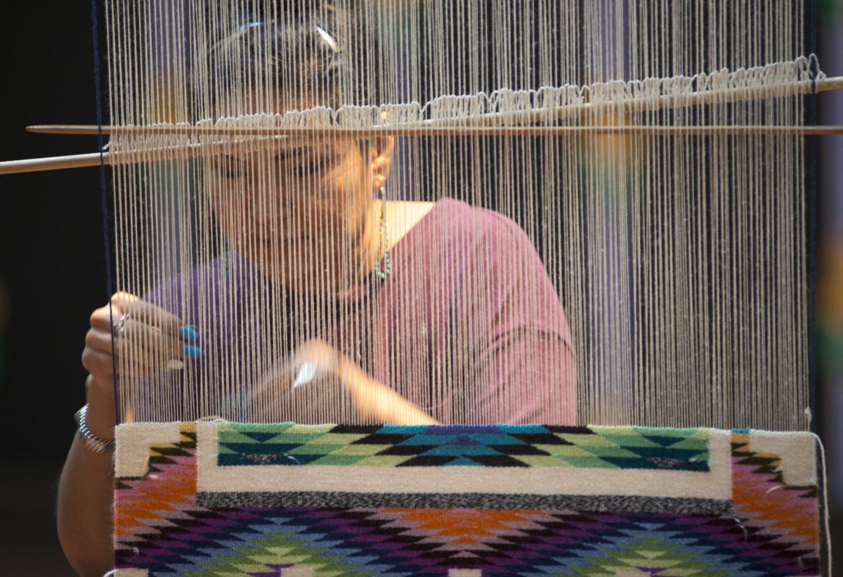 A Navajo (Diné) Woman Weaving on a Loom