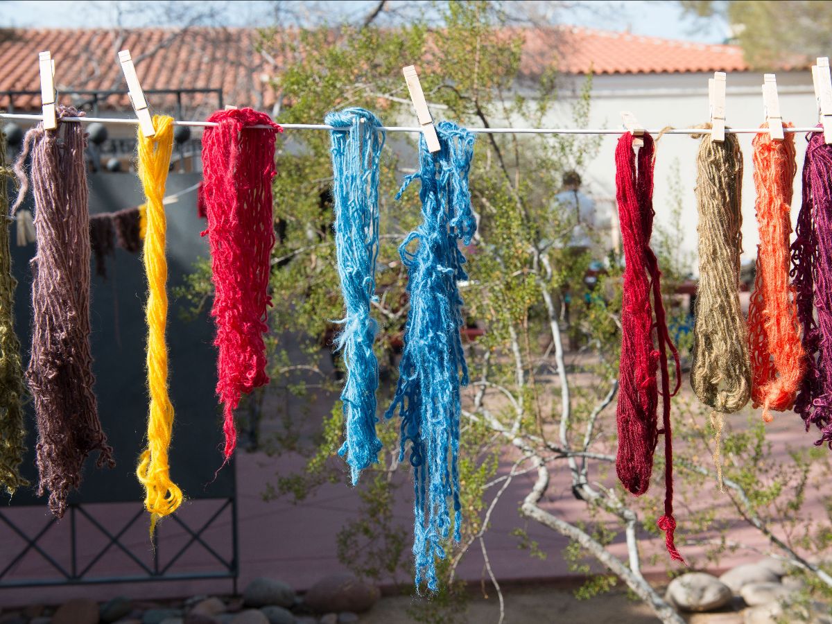 wool hanging to dry after being dyed